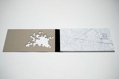 two pieces of paper cut out to look like maps