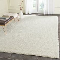 a large white rug in a living room