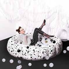 a woman laying on top of an inflatable bubble chair with bubbles around her