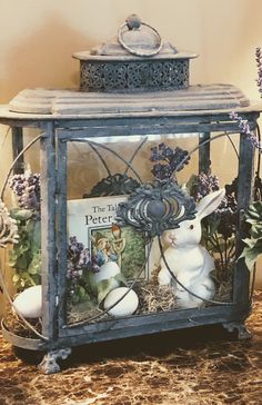 a glass box filled with easter decorations and an egg