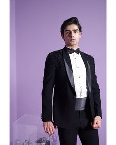 Nightfall Tuxedo Set - Contrast by Parth Adorned with a dazzling array of 3D crystals, cutdana, and Swarovski elements, this breathtaking piece captures the enchanting allure of falling stars. Its exquisite design is perfectly complemented by a stylish tux sash, creating a mesmerizing ensemble. Included in purchase: Tuxedo, Shirt, Pants, Bowtie and Sash Product Specification Color: Black (can be customized) Fabric: Italian Suiting Occasion: Formal Event, Wedding, Bridal, Reception Style: Tuxedo Wedding 3 Piece Suit For Men, Black Tuxedo For Men, Hand Embroidery Indian, Designer Tuxedo, Embroidery Indian, Tuxedo Shirt, Wear Store, Indian Wedding Wear, Falling Stars