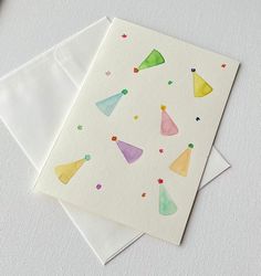 two greeting cards with party hats on them