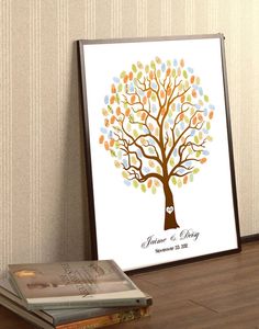 a wedding guest book next to a framed family tree