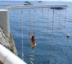 a woman hanging off the side of a boat