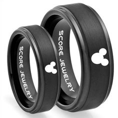 two black rings with mickey mouse and mickey mouse engraved on the inside of each ring