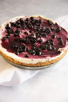 a pie sitting on top of a table covered in blueberry cheesecake toppings