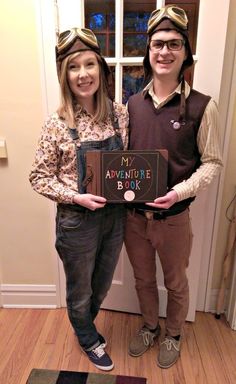 two people standing next to each other in front of a door holding an adventure book