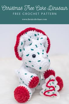 a crocheted white and red stuffed animal with the words christmas tree cake dinosaur on it