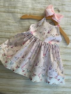 ★*.*'.*★Princess & Friends Toddler Dress★*.*'.*★ The dress is a sundress style, with extra long straps to make a fancy bow at the back.  The back has elastic for a snug fit. The bottom is trimmed with a Coordinating fabric  for an extra fancy style. Beautiful soft shade of pink. Ready to ship Available in sizes 2T & 3T Care Instructions: Dresses are made from 100% Cotton and wash best on cold / hang to dry to prevent shrinking* Playful Sleeveless Dress With Tie Straps, Playful Summer Dress With Tie Straps, Spring Dress With Bow Straps For Dress-up Occasions, Cute Cotton Dresses With Tie Straps, Cute Cotton Dress With Tie Straps, Fitted Whimsical Twirl Dress For Summer, Whimsical Fitted Twirl Dress For Summer, Summer Cotton Dress With Bow Straps, Beach Cotton Dress With Bow