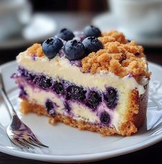 a piece of blueberry cheesecake on a white plate