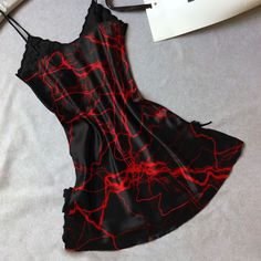 Indulge in luxurious comfort and stunning style with our Women's Red Lace Nightgown. Made with a smooth, stretchy, and lightweight fabric, this chemise offers a comfortable fit for all night wear. The combination of red lace and gothic symbols is sure to turn heads. With a slim fit design and plunging V-neckline, this chemise will accentuate your curves in all the right places. Perfect for a romantic evening, the dual side slits add a touch of sexiness to this beautiful piece. Exquisite Material Party Chemise With Built-in Bra And Spaghetti Straps, Fitted Satin Sleepwear With Spaghetti Straps, Sleeveless Chemise For Night Out, Summer Chemise With Spaghetti Straps For Night Out, Satin Nightgown With Spaghetti Straps For Night Out, Satin Chemise With Spaghetti Straps For Night Out, Elegant Red Sleepwear For Night, Red V-neck Camisole For Sleep, Fitted Camisole Mini Dress For Night