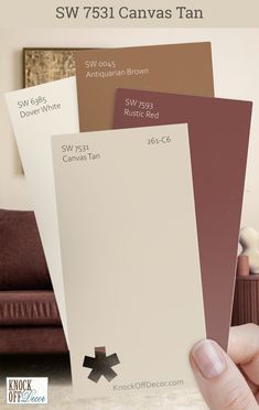 a hand holding three different shades of brown, white and tan paint swatches with the text sw 751 canvas tan