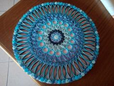 a blue plate sitting on top of a wooden table next to a white tile floor