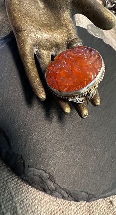 A unique floral Carnelian deeply carved antique hand wrought Ring.  Size approx.-5, wt.- 6.2 grams,  The Carnelian is 22mm in diameter and exquisitely carved-An artist sterling ring from the early 1900's.  Carnelian is one of my favorite stones the color is earthy and easy to wear.  The carnelian carving appears to be an antique chinese export genuine stone carving. Carved Carnelian Vintage Jewelry, Vintage Carved Carnelian Jewelry, Antique Carved Carnelian Jewelry, Chinese Export, Stone Carving, Early 1900s, Sterling Ring, Rings Statement, Statement Rings