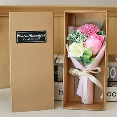 a bouquet of flowers in a box on a table