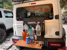 the back end of a white truck with bottles on it