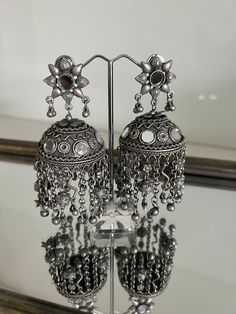 Kaach tribal Jhumka silver look earrings Is a statement earrings It quirky and stylish  Made out of brass will dangling detailing Mirror detailing 9cm in length  NOTE: Since this product is handcrafted it has slight irregularities which only adds uniqueness. Any questions please feel to ask Oxidized Brass Jhumkas, Metal Jhumkas For Pierced Ears For Festival, Metal Jhumkas For Festival, Pierced Ears, Festive Oxidized Brass Jhumkas, Traditional Brass Jhumkas With Oxidized Finish, Silver Oxidized Metal Chandelier Earrings, Traditional Oxidized Brass Jhumkas, Silver Chandelier Earrings With Oxidized Finish, Bohemian Drop Jhumkas In Metal