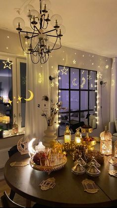 a dining room table is set with candles and other items for the holiday dinner party