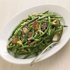 a white bowl filled with green beans and nuts