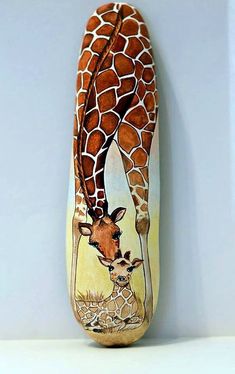 a giraffe painted on the side of a wall with words above it that read painted stone sasso dip into a mano giraffe