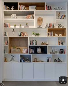 a white book shelf filled with lots of books