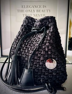 This stylish black bag is hand crocheted from high quality raffia. It is perfect for all occasions and offers both functionality and fashion. The bag has an elegant and unique look that complements any outfit. Ideal for everyday use or special occasions. Trendy Woven Crochet Shoulder Bag, Luxury Black Straw Bag For Everyday Use, Elegant Crochet Shoulder Bag With Leather Handles, Luxury Black Straw Bag With Braided Handles, Elegant Crochet Bag With Woven Leather For Daily Use, Elegant Straw Crochet Bag With Leather Handles, Elegant Crochet Straw Bag With Leather Handles, Elegant Woven Leather Crochet Bag For Daily Use, Elegant Crochet Bag With Leather Handles