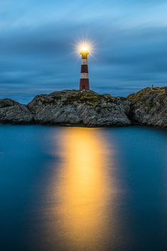 a light house sitting on top of a small island