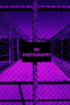 a purple fence with a no photography sign on it