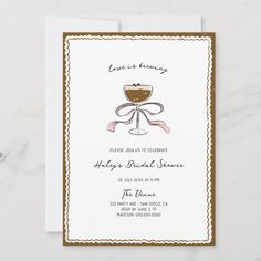 a white and brown wedding card with a glass of wine on the front, in gold trimmings