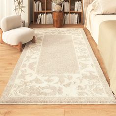 a large white rug in a bedroom next to a chair and bookshelf on the floor