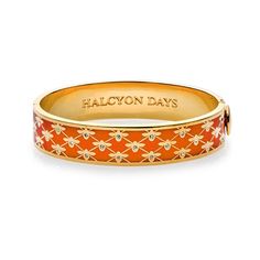 A bangle with a buzz, this 18k gold plate and enameled bracelet is made by a company that has a history of fine artisanal enameling craftsmanship. Halcyon Days, Orange And Gold, Gold Bangle, Hinged Bangle, Gold Bangles, Sunglasses Case, Leather Bracelet, 18k Gold, Gold Plate