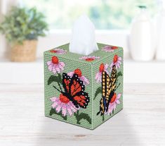 a tissue box decorated with flowers and butterflies