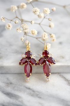 Burgundy Crystal Earrings featuring rare dark red crystals are perfect for bridesmaids or anyone looking to add a sophisticated touch of color. They are ideal for special occasions or as a unique gift. Custom orders are available for matching bracelets.  Details :  ● Materials- 14k Gold, Rose gold, Or Silver Plated, Premium Quality European Crystals ● Choose your style of plating at checkout  ● U.S packages shipped via USPS® insured+USPS® tracking number  ● Handcrafted with genuine crystals  ● D Elegant Red Cluster Earrings For Wedding, Burgundy Drop Earrings For Party, Burgundy Earrings For Party, Dark Red Crystals, Burgundy Earrings, Color Earrings, Earrings Bridesmaid, Crystal Drop Earrings, Red Crystals