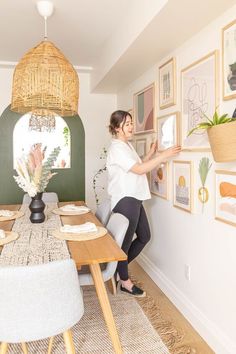 a woman standing in front of a dining room table