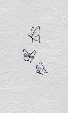 three butterflies flying in the air on top of a white paper background with black ink