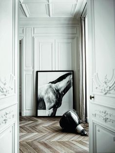 a black and white photo sitting on top of a hard wood floor