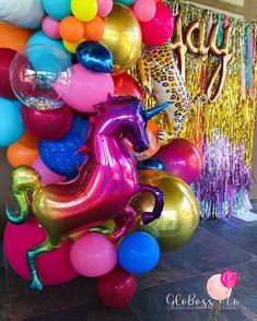 a bunch of balloons that are in the shape of horses and unicorns on display