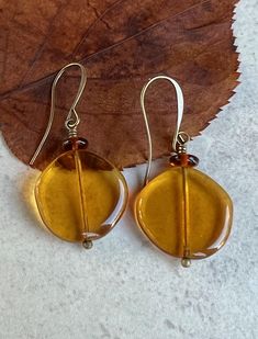 boho yellow czech glass dangle earrings * smooth and shiny Czech glass off-round discs - 20mm * transparent honey yellow color * small brown Czech glass disc sits on top * antiqued brass hook ear wires * total length - 1 3/4" * you can enter my shop here:    gypsydangles.etsy.com Hypoallergenic Round Glass Earrings, Amber Czech Glass Earrings With Ear Wire, Nickel-free Amber Czech Glass Earrings, Hypoallergenic Brown Round Earrings, Hypoallergenic Czech Glass Round Earrings, Hypoallergenic Round Czech Glass Earrings, Honey Yellow Color, Boho Yellow, Honey Yellow