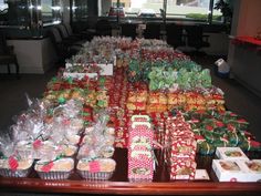 a table filled with lots of different types of wrapped presents and candy bars on top of it