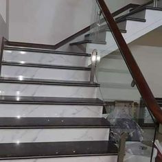 the stairs are made of marble and have metal handrails