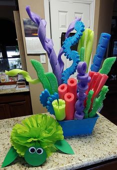 a vase filled with different colored items on top of a counter