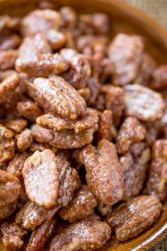 slow cooker candied pecans in a bowl with the words slow cooker candies