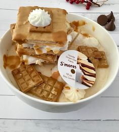 a white bowl filled with waffles covered in syrup and marshmallows