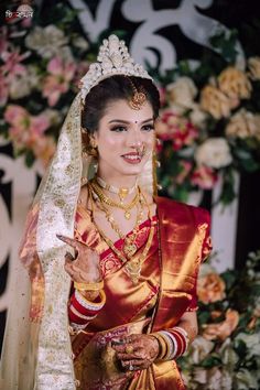 a woman in a red and gold wedding outfit