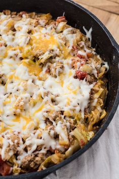 a casserole dish with meat, cheese and other toppings in a cast iron skillet