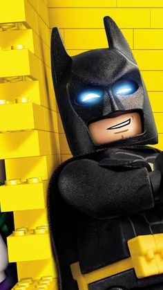 the lego batman movie character is standing in front of a yellow wall