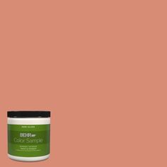 a jar of marquee paint on a green background