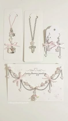 three different necklaces with bows on them and tags attached to the back of them