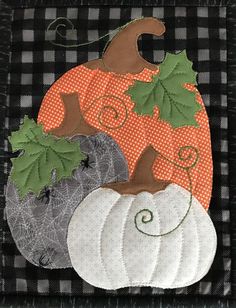 a black and white checkered table cloth with pumpkins, leaves and acorns