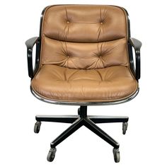 a brown leather office chair with wheels and casteors on an isolated white background, viewed from the front